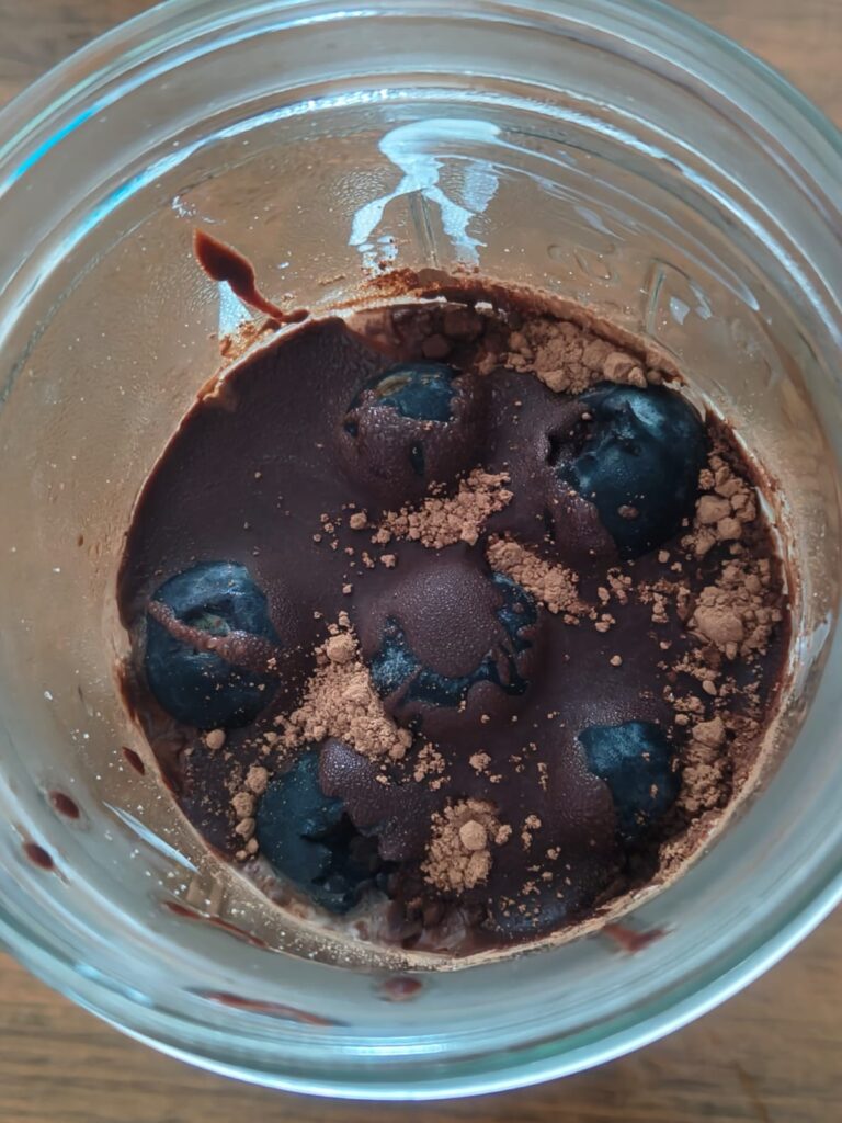 Chocolate blueberry overnight oats in a glass jar